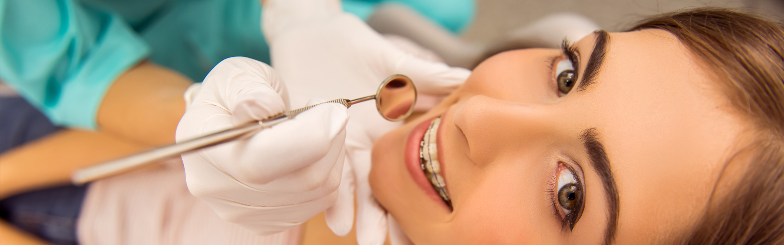 Teen girl with a great smile, wearing braces at Dreamworks Dental Arlington
